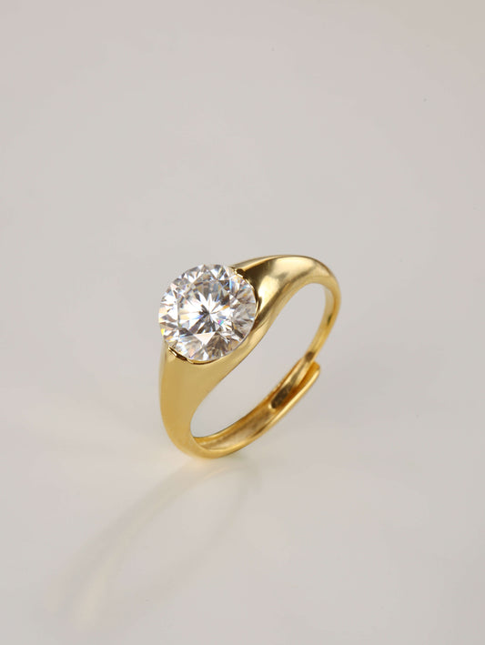 A close-up of a hand wearing the minimalist 2ct moissanite dome ring in gold, highlighting the smooth, chunky silhouette and radiant sparkle.