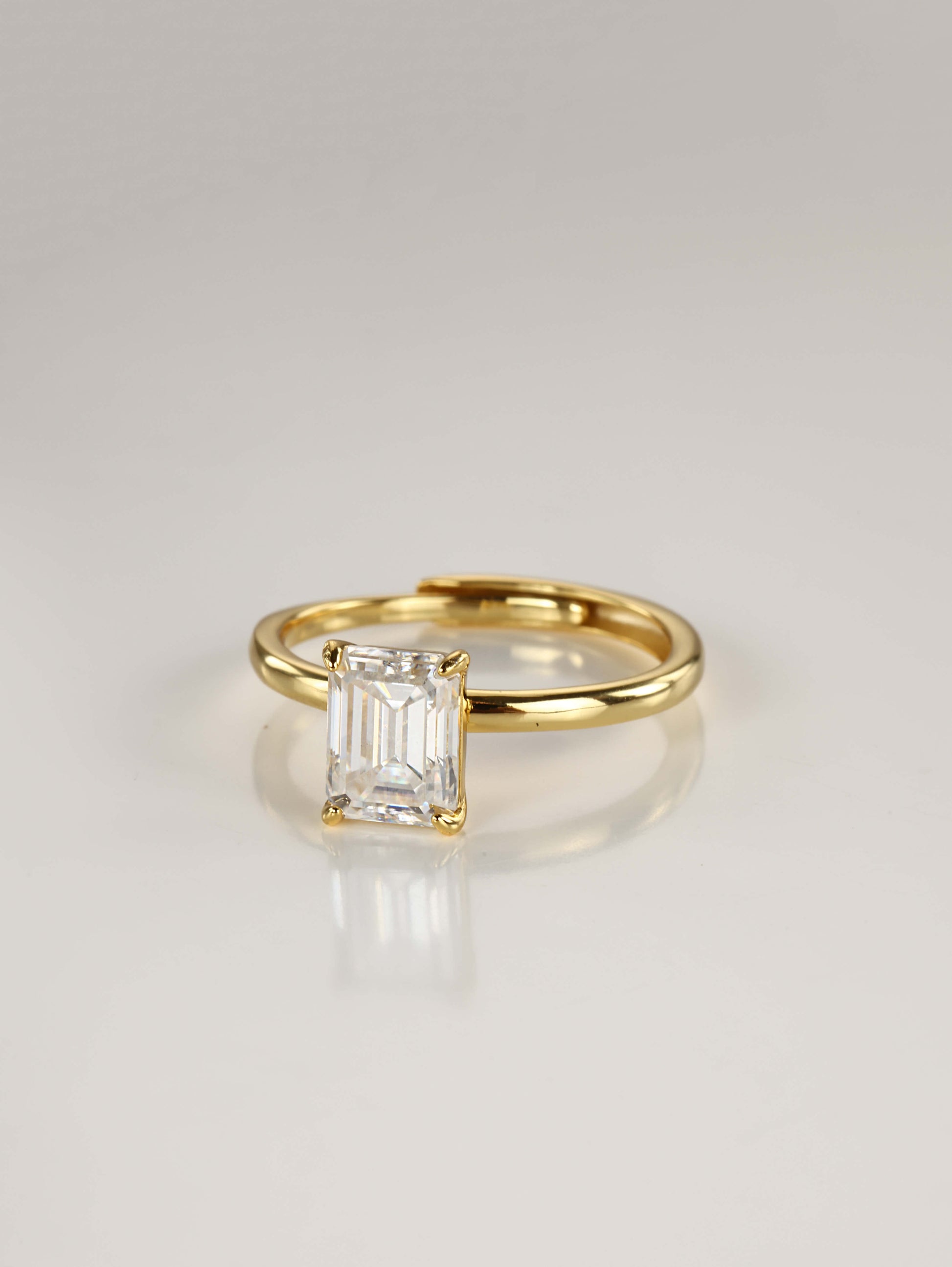 A sleek 925 sterling silver adjustable ring featuring a brilliant emerald-cut moissanite centre stone in a minimalist 4-prong setting.