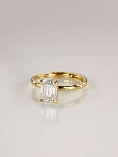 A sleek 925 sterling silver adjustable ring featuring a brilliant emerald-cut moissanite centre stone in a minimalist 4-prong setting.