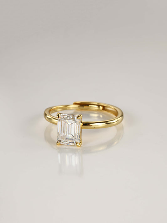 A sleek 925 sterling silver adjustable ring featuring a brilliant emerald-cut moissanite centre stone in a minimalist 4-prong setting.