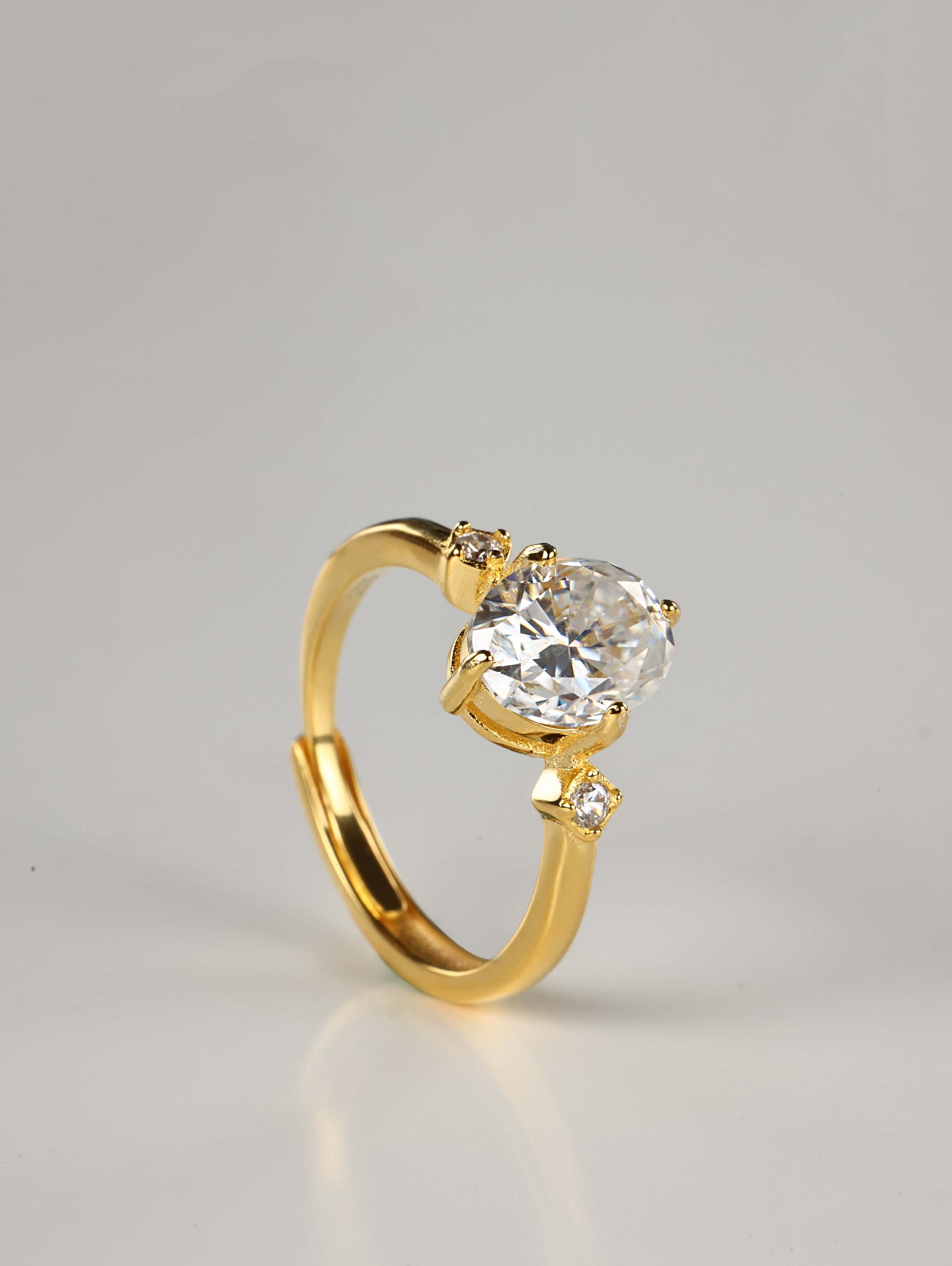 Hidden adjustable open back band on a 2ct oval trilogy sterling silver ring