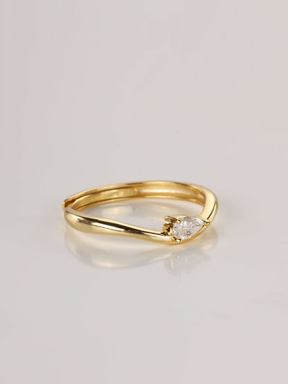 A modern 925 sterling silver wavy stacking ring featuring a 0.5ct pear-cut moissanite centre stone.