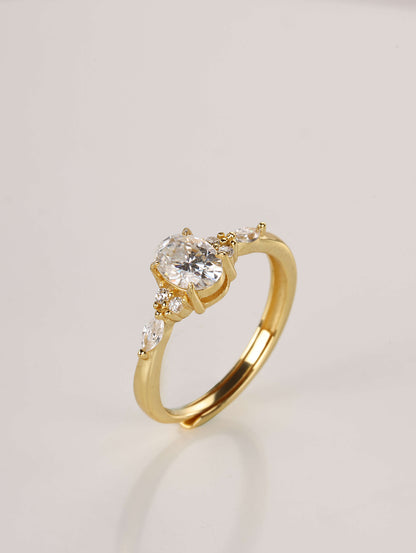 Close-up macro shot of the 1-carat oval moissanite ring showing the intricate cluster setting and polished gold band details.