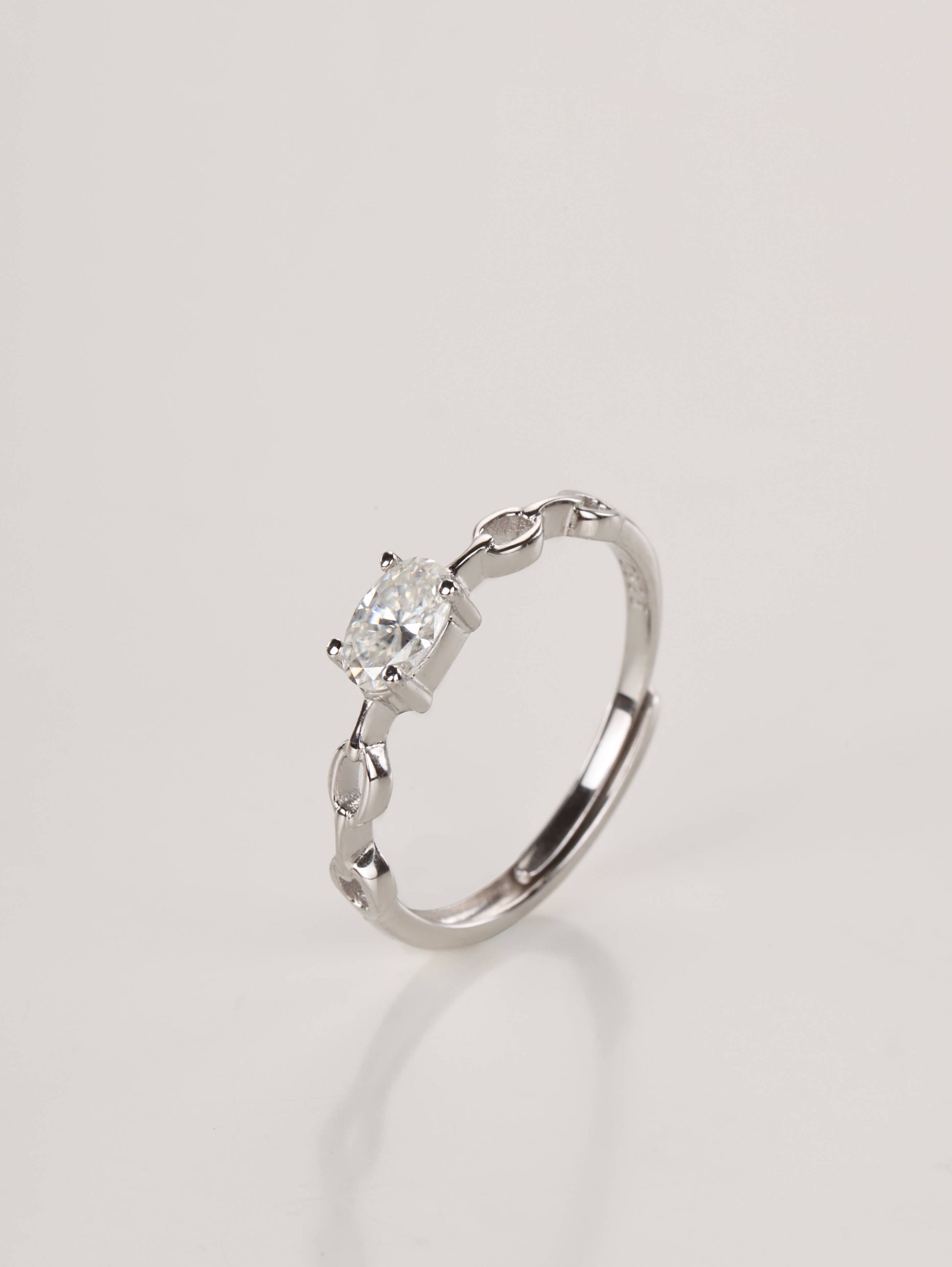 A close-up of a hand wearing the adjustable silver 0.5ct oval chain ring, demonstrating the modern aesthetic and everyday styling in natural light.