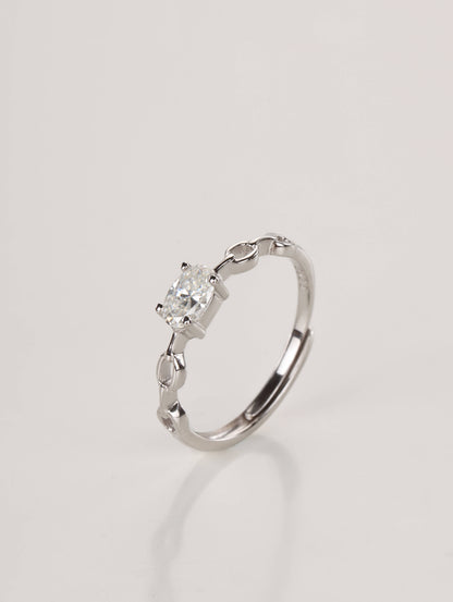 A close-up of a hand wearing the adjustable silver 0.5ct oval chain ring, demonstrating the modern aesthetic and everyday styling in natural light.