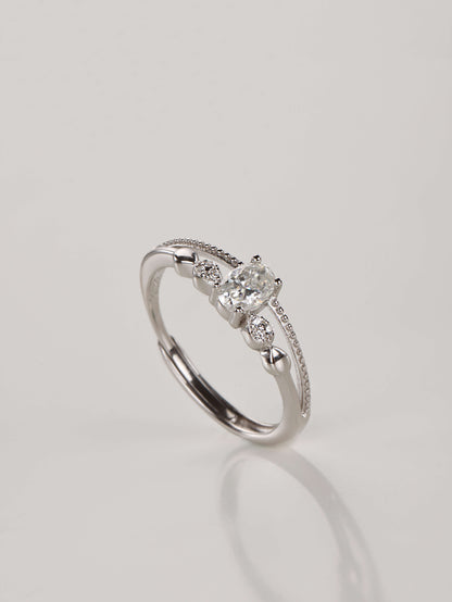 A close-up of a hand wearing the adjustable double layer 0.5ct oval moissanite ring, demonstrating the stacked illusion and sparkle in natural lighting.