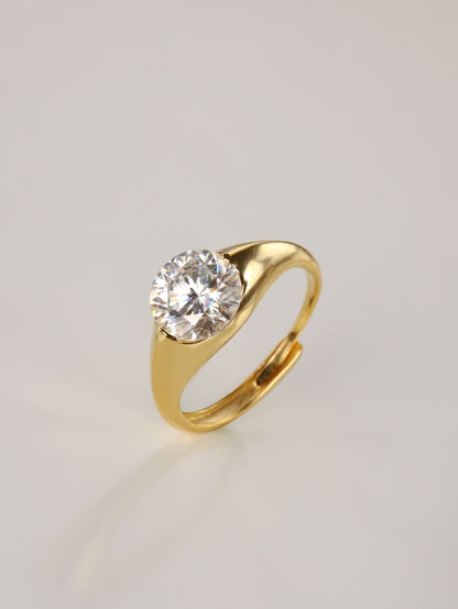 A close-up of a hand wearing the minimalist 2ct moissanite dome ring in gold, highlighting the smooth, chunky silhouette and radiant sparkle.