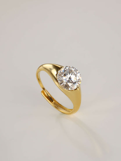 The modern 2-carat round moissanite minimalist ring resting gracefully beside its signature luxury gift box and protective microfibre pouch.