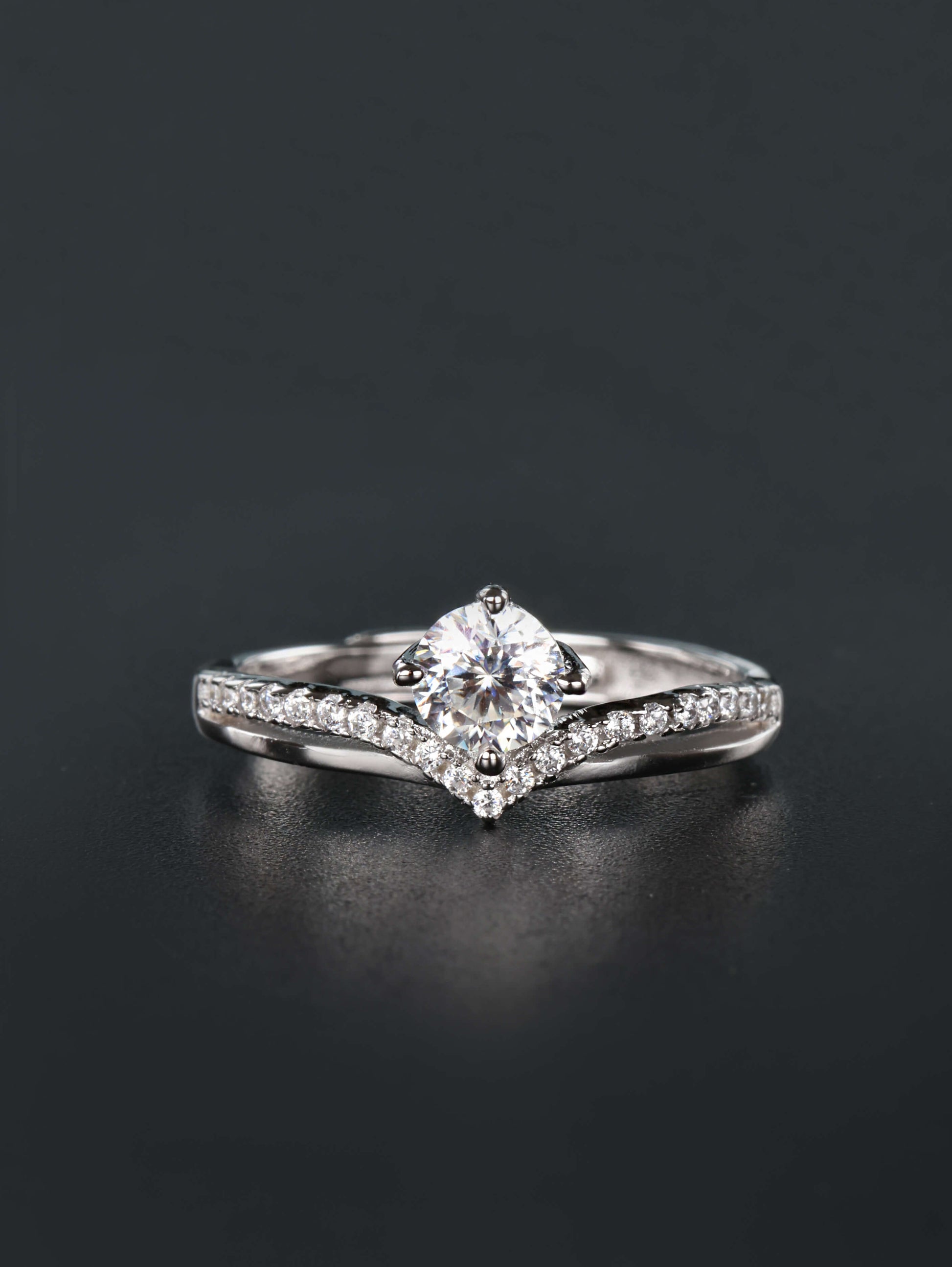 Chevron V-band crown ring in 925 silver with round solitaire moissanite worn as an engagement ring stacker