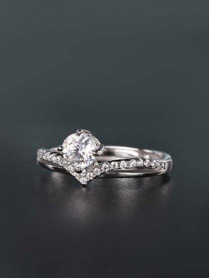 Adjustable open-back band detail on a silver crown chevron ring with a round prong-set moissanite gem