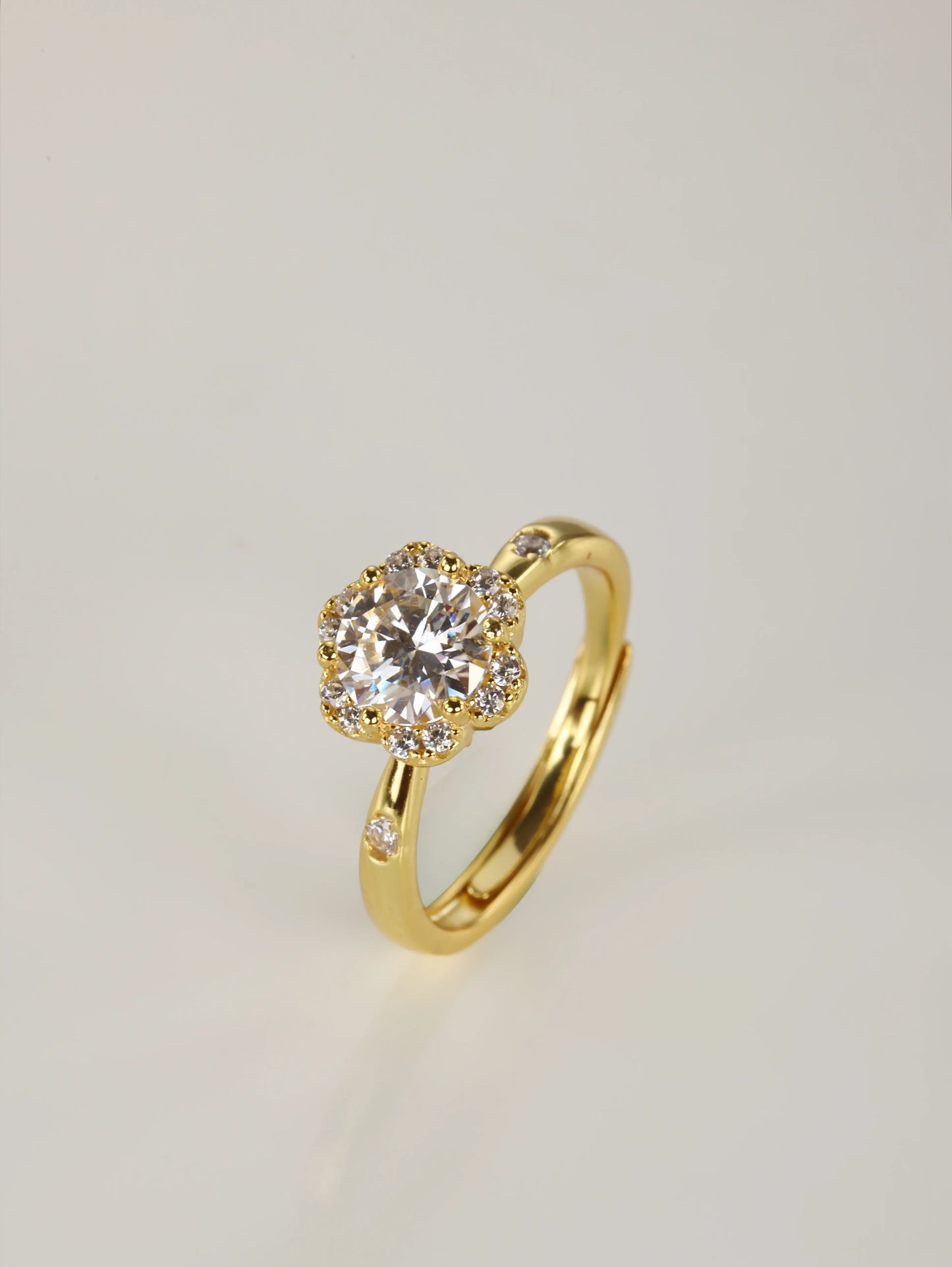 A close-up of a hand wearing the 1ct flower design moissanite ring, demonstrating the sparkling halo effect and everyday elegance in natural lighting.