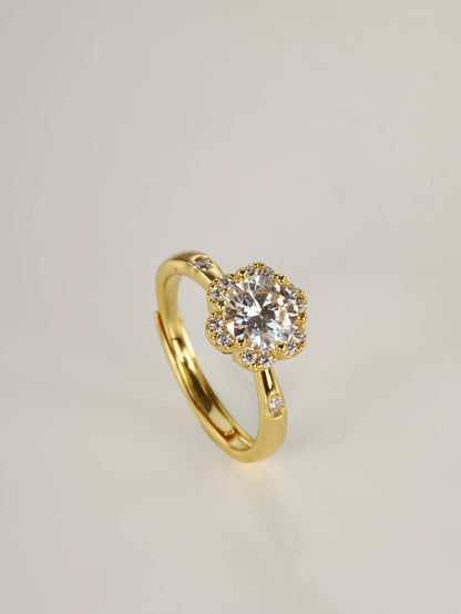 The romantic 1-carat floral halo ring displayed beautifully next to its signature luxury gift box and protective microfibre pouch.
