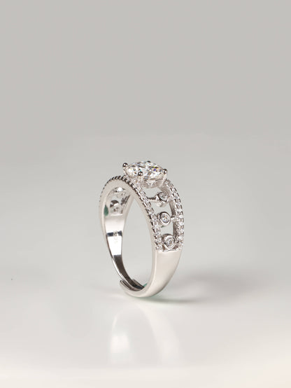 Wide geometric openwork lace ring in silver with a round solitaire gemstone worn on a finger