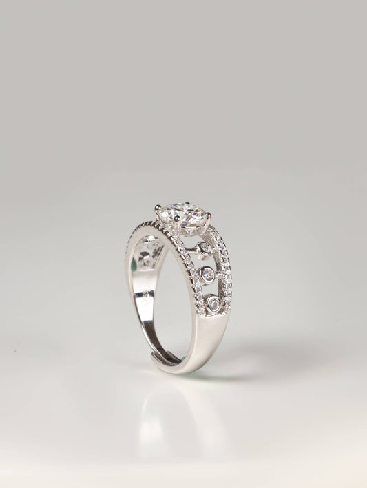 Wide geometric openwork lace ring in silver with a round solitaire gemstone worn on a finger