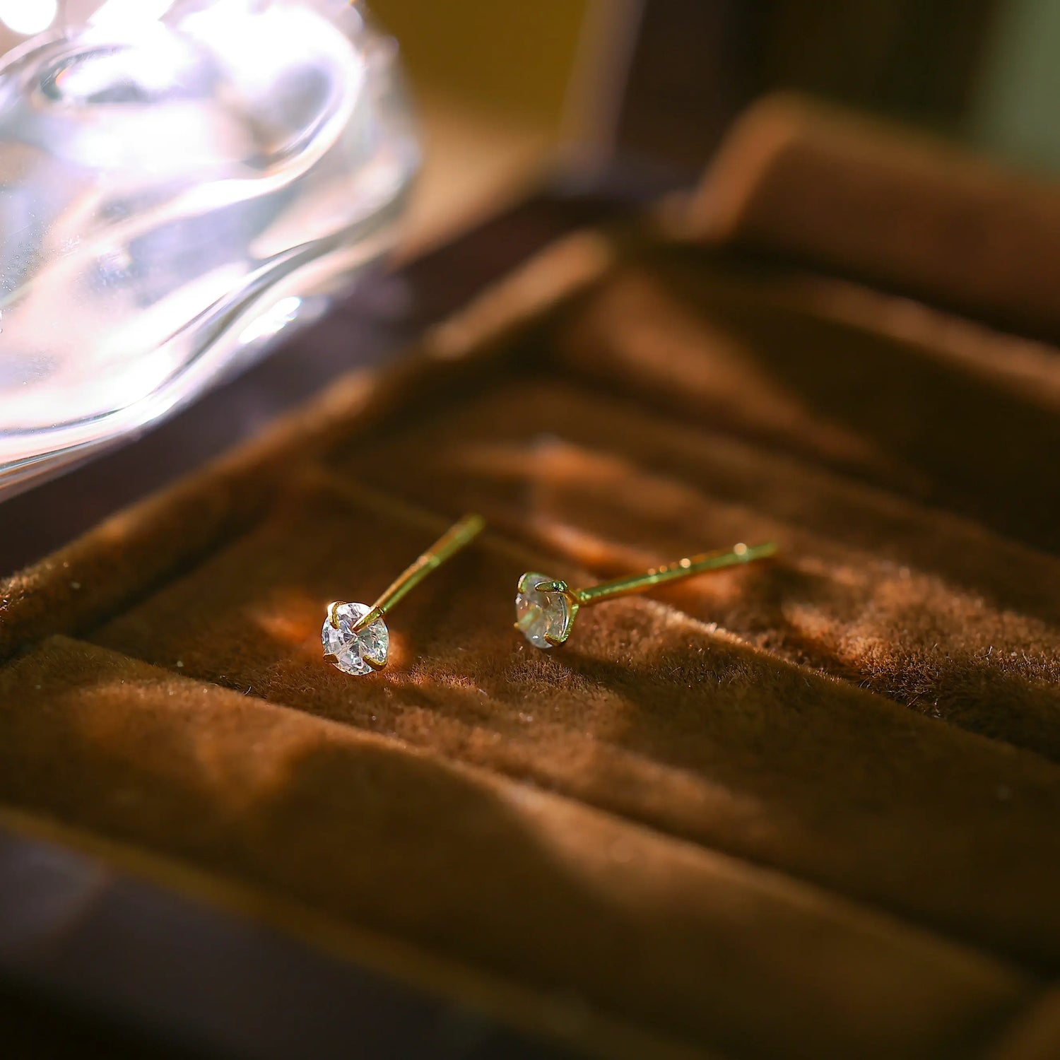 Pair of 14K gold plated sterling silver stud earrings with 3mm cubic zirconia stones.