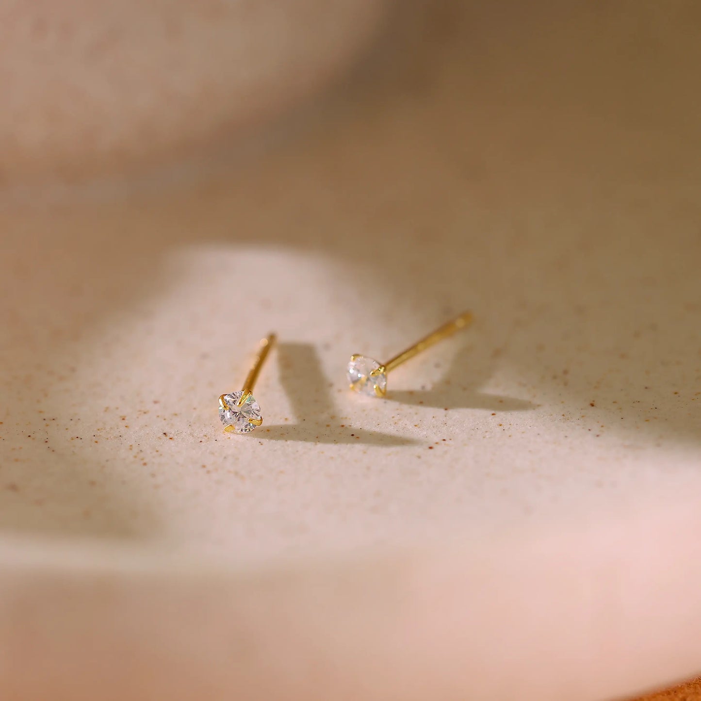 Side view of the stud earring showing the gold post and setting height.