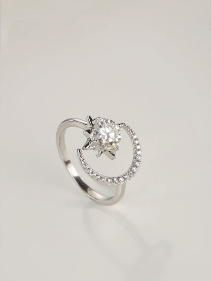 A close-up of a hand wearing the adjustable moon and star moissanite ring, showcasing the asymmetrical celestial design in natural lighting.