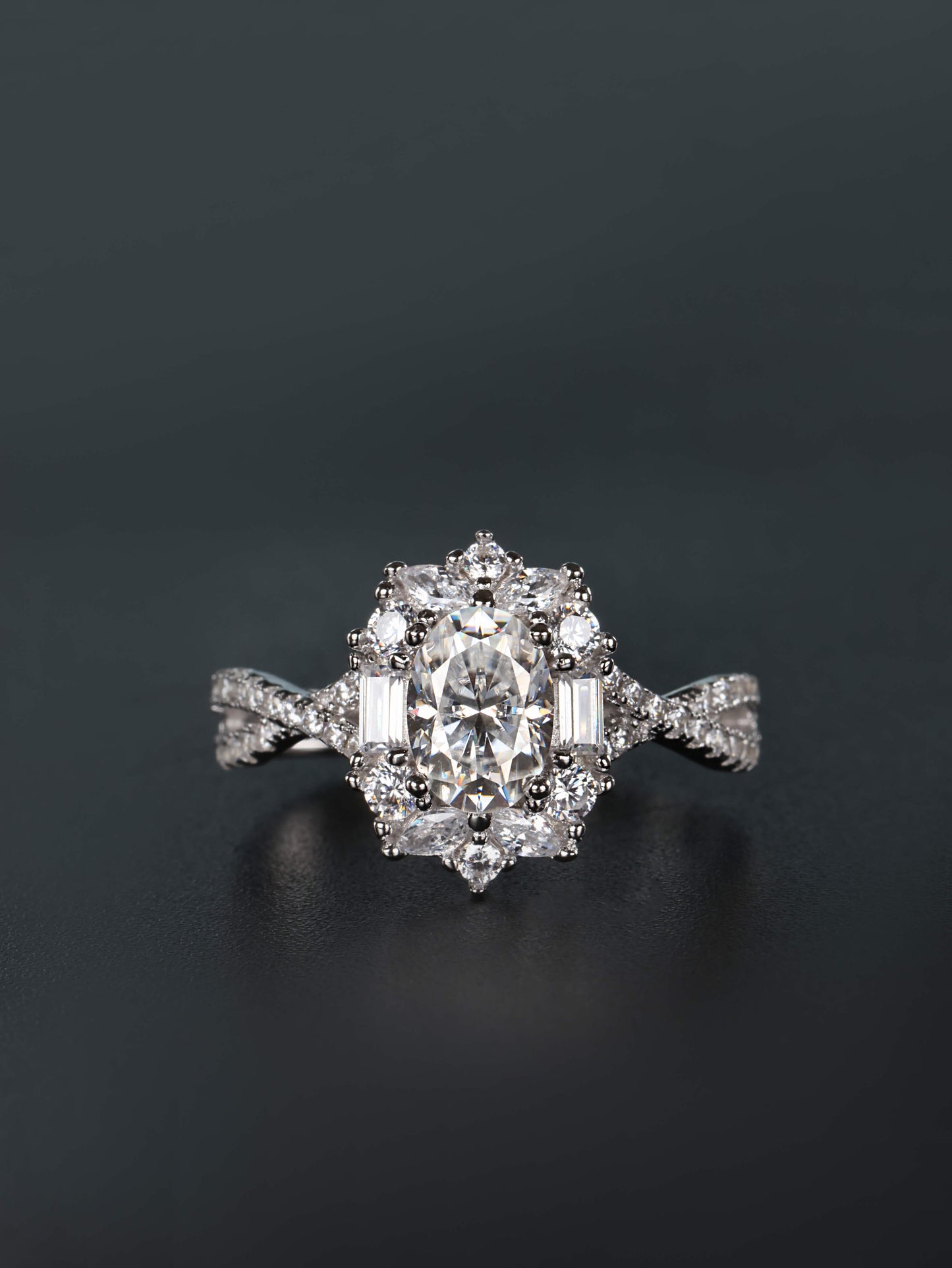 1ct oval moissanite ring with mixed baguette and round stone halo cluster on twisted pavé silver band
