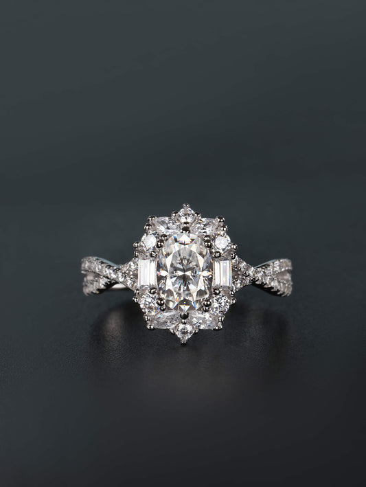 1ct oval moissanite ring with mixed baguette and round stone halo cluster on twisted pavé silver band