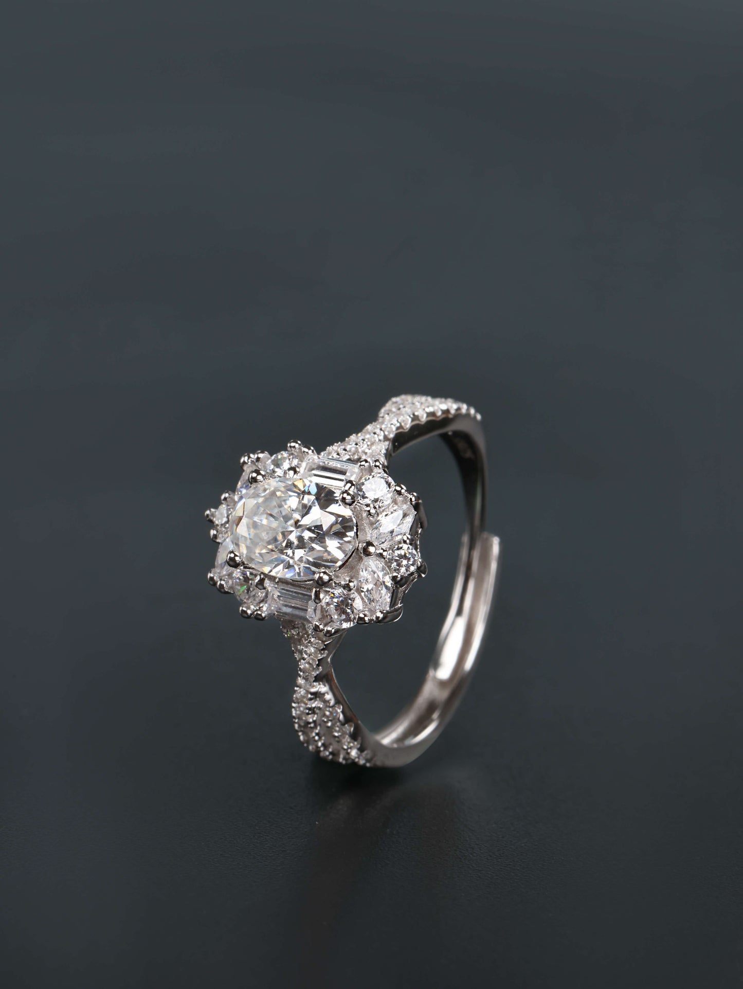 Hidden adjustable open back band detail on a silver oval halo moissanite engagement ring