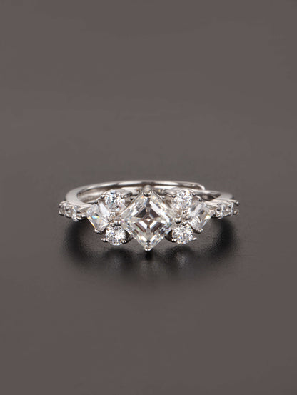 A close-up of a hand wearing the 1ct square cut moissanite ring, highlighting the geometric kite setting and brilliant side stones in natural lighting.