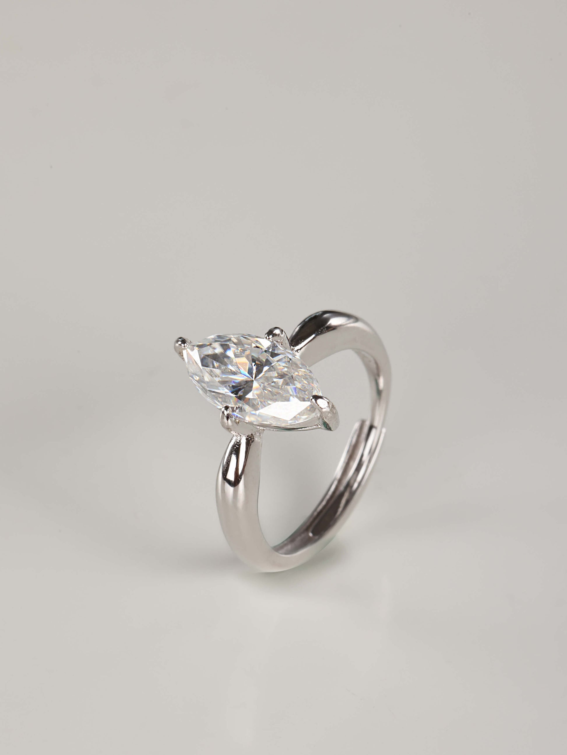 An elegant portrayal of a breathtaking 2-carat marquise moissanite ring, ideal as an alternative engagement or promise ring. Handcrafted in 925 silver with a brilliant-cut center stone and V-prongs, this statement solitaire rests on a neutral, professional studio backdrop.
