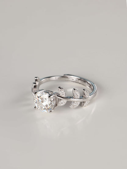 Close up of a woman wearing a 1 carat botanical moissanite engagement ring on her index finger