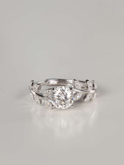 1ct brilliant round cut moissanite ring with silver leaf vine band on white background