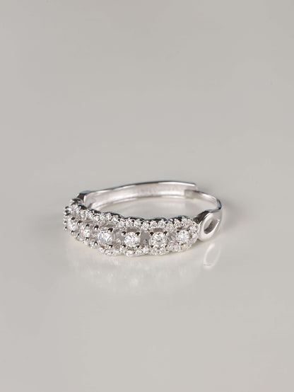 Top-down view of a silver Art Deco half-eternity ring with 0.41 carats of moissanite. The image highlights the delicate, lace-like scalloped edges and the continuous row of brilliant-cut stones set in a high-polish 925 sterling silver band.