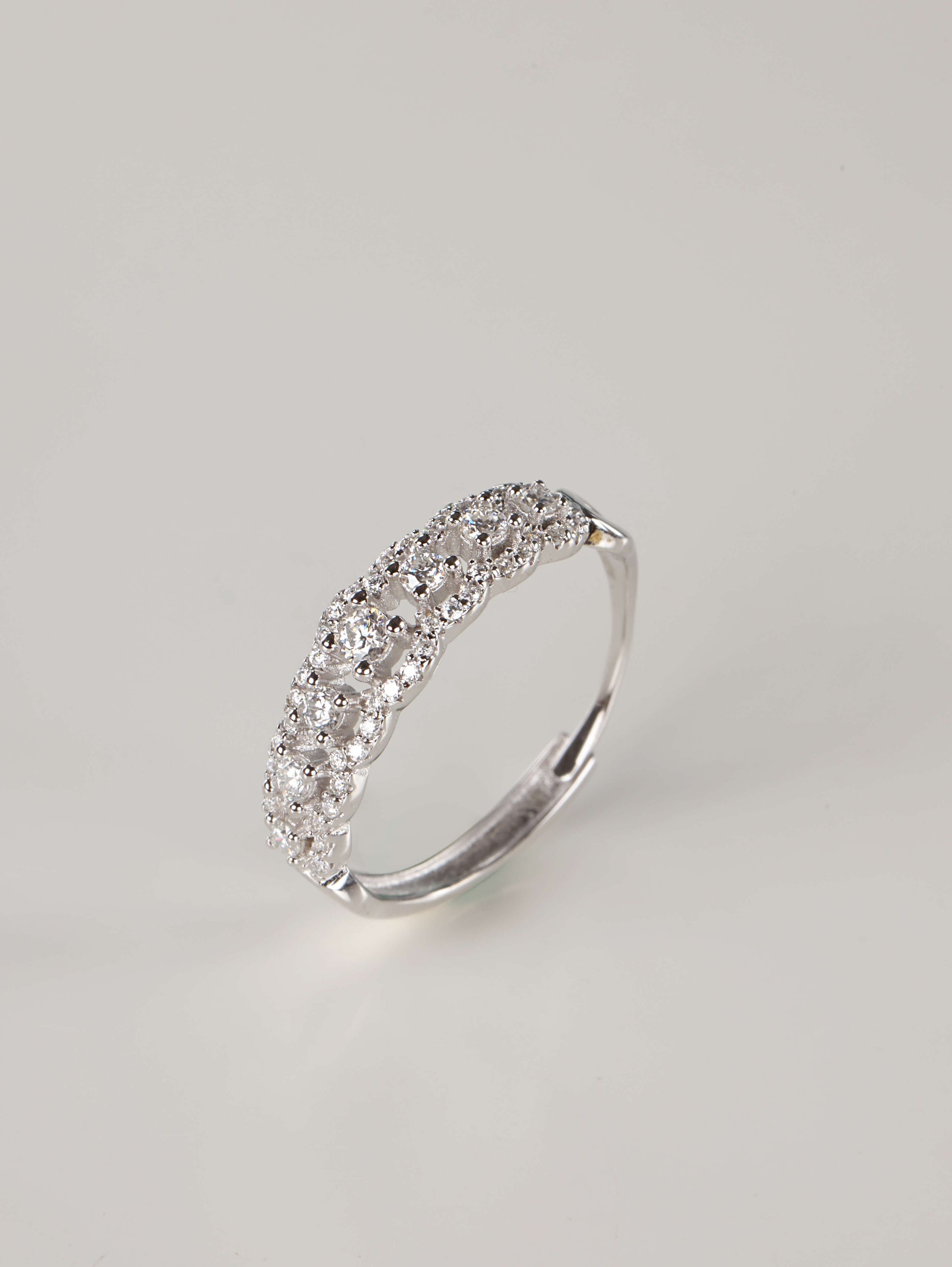 A side and back profile of an adjustable silver moissanite lace ring, revealing the discrete open-back band design. The front of the ring shows 0.41ct of brilliant stones set in a detailed, vintage-inspired scalloped pavé pattern.