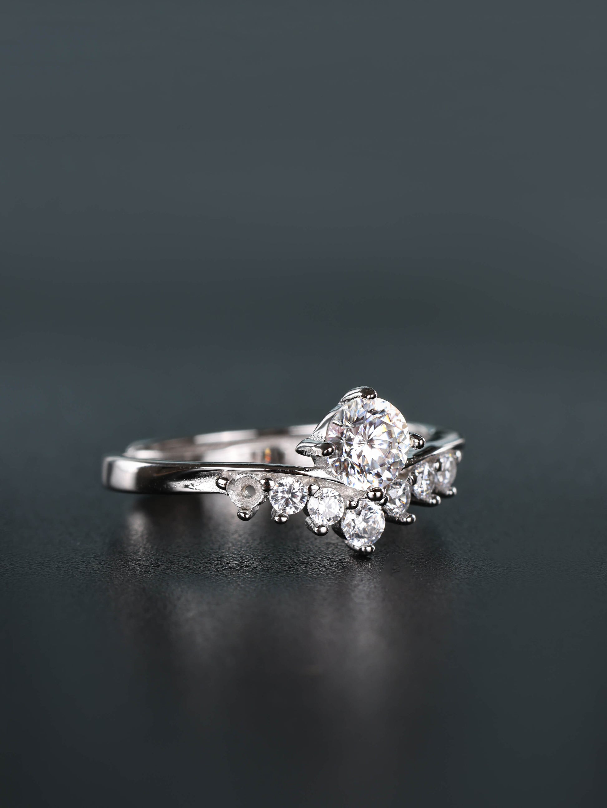 A woman's hand wearing an adjustable 0.5ct chevron moissanite ring in 925 sterling silver, highlighting how the V-shape design elegantly elongates the finger.