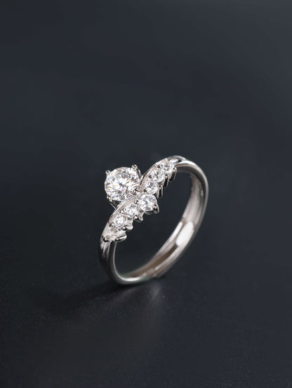 A profile angle of a silver V-shape stacking ring, showcasing the 0.5ct moissanite centre stone and the discrete open-back adjustable band design.