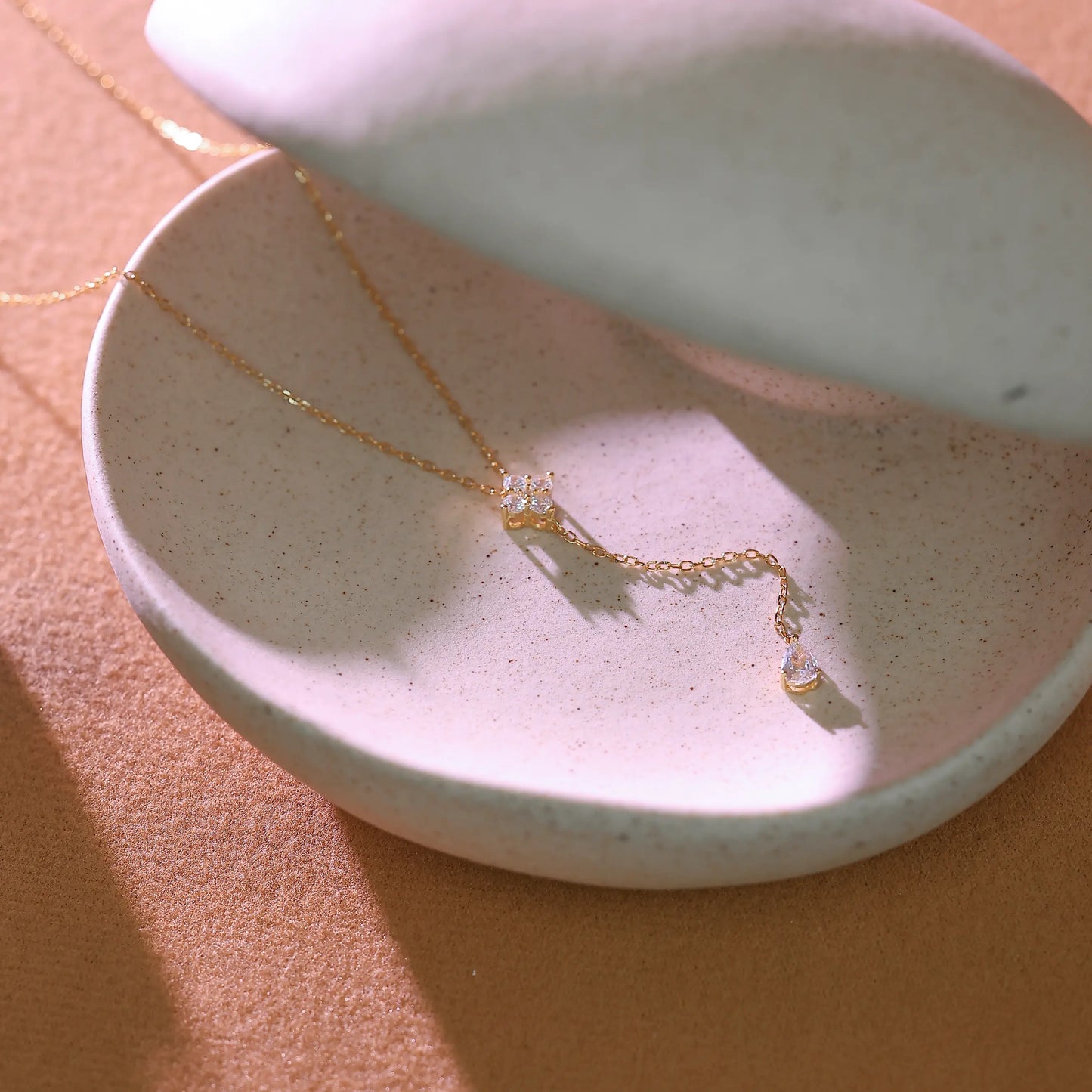 Close-up view of 14k gold plated lobster clasp, adjustable extender chain, and '925' sterling silver stamp.