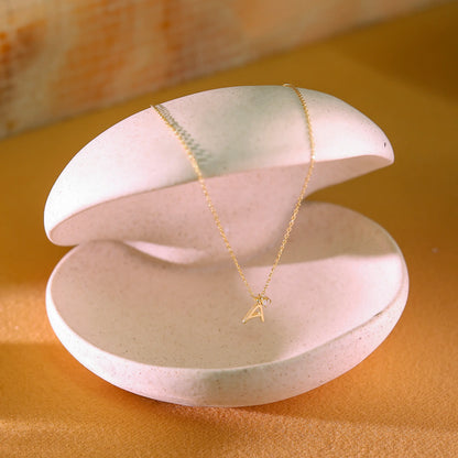 Side profile of gold letter pendant showing thick 14k gold vermeil finish. High-quality demi-fine personalized jewellery designed in London