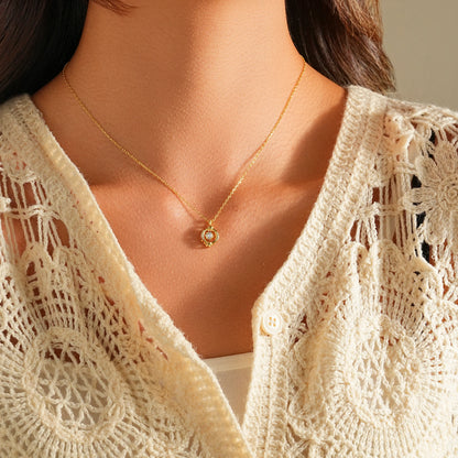Woman wearing a dainty floating diamond solitaire necklace with a white shirt.