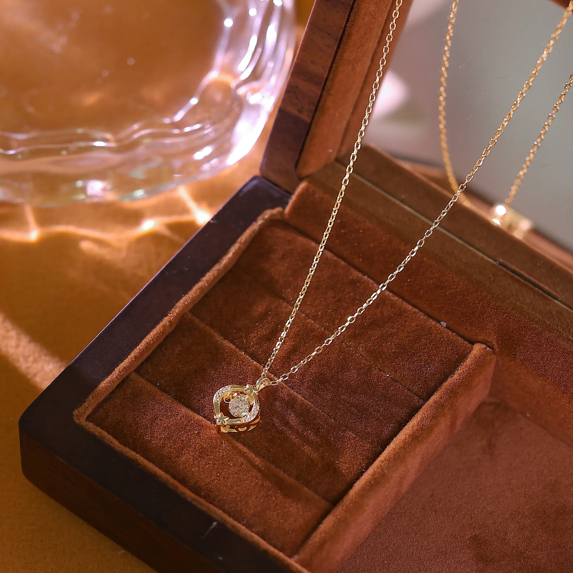 Macro shot of round brilliant cut diamond simulant in a minimal gold setting.