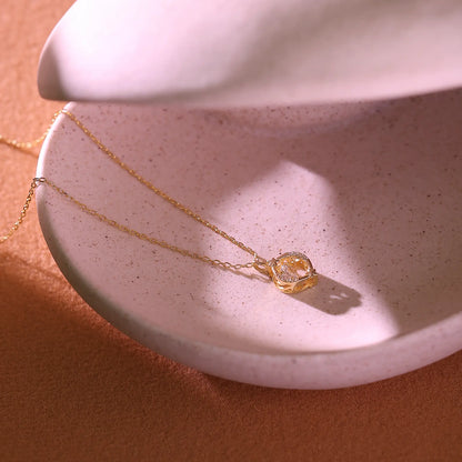 Gold necklace with a diamond pendant and two stars displaying on white background