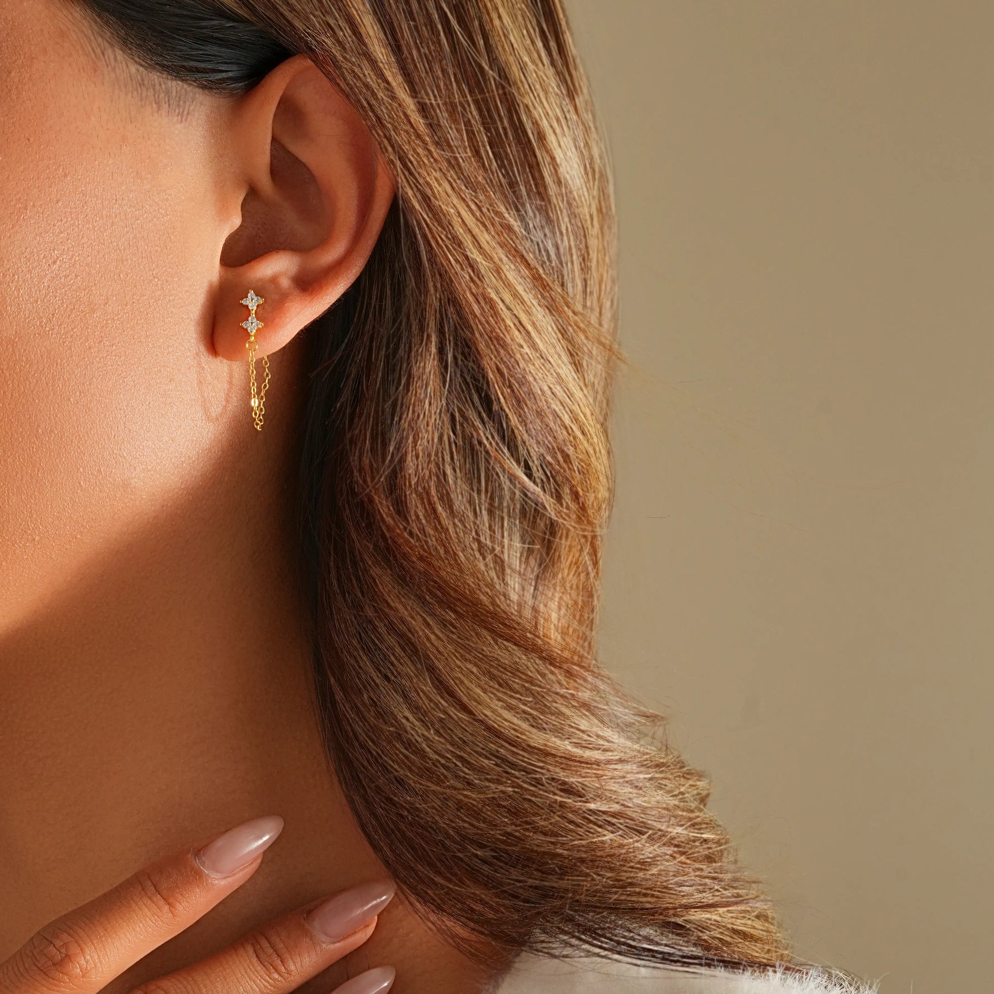 Side profile of model showing the movement of the diamond chain drop earrings