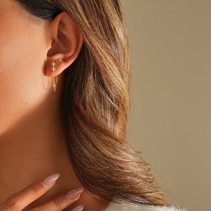 Side profile of model showing the movement of the diamond chain drop earrings