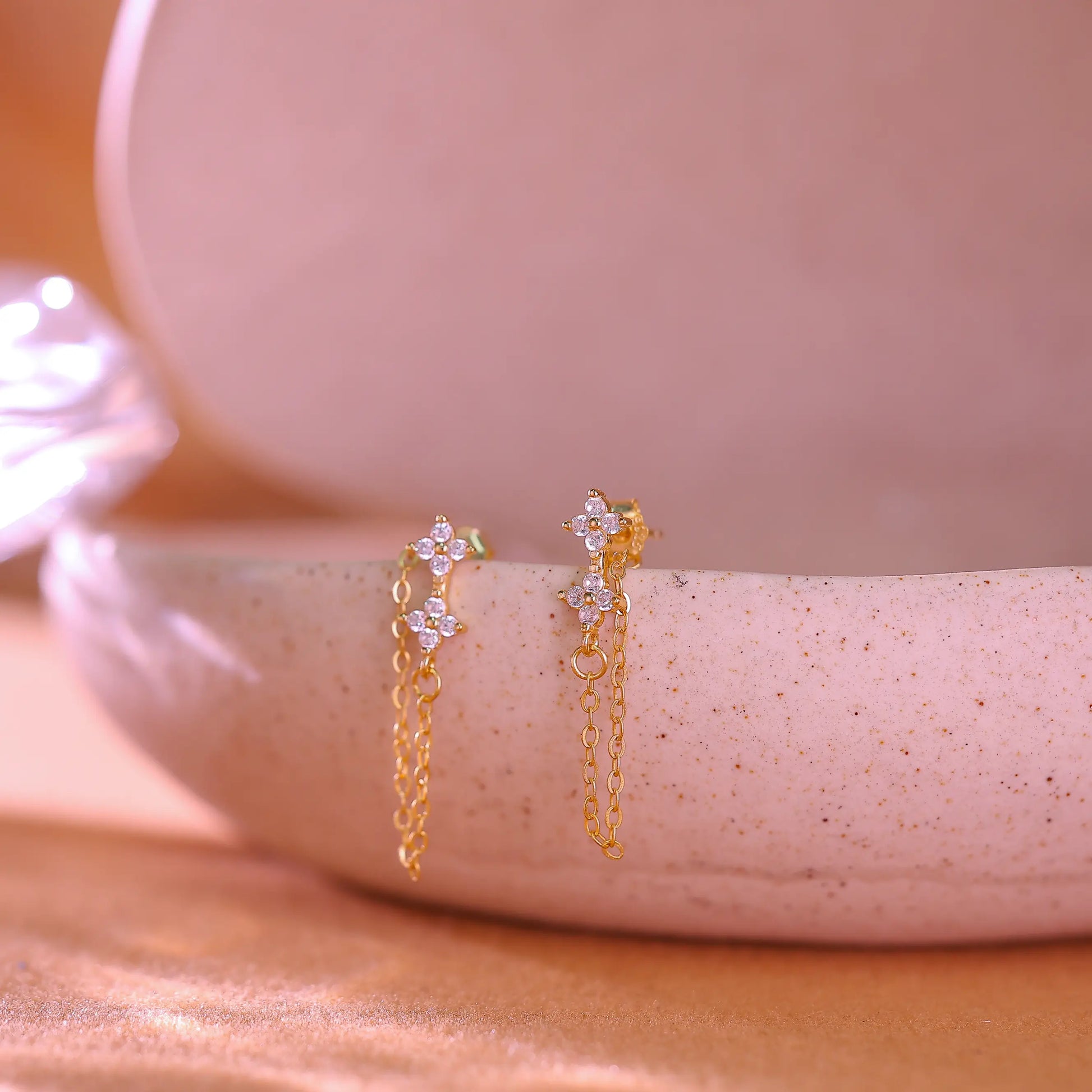 14K gold plated sterling silver earrings featuring a crystal flower stud and long chain drop.