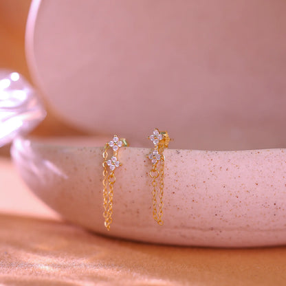 14K gold plated sterling silver earrings featuring a crystal flower stud and long chain drop.