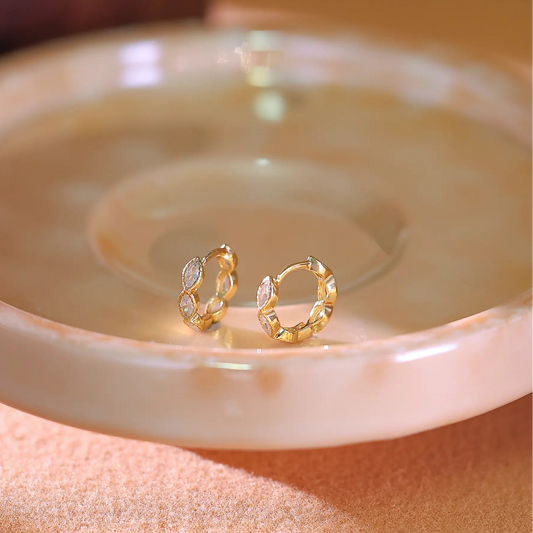 14K gold plated hoop earrings set with marquise cubic zirconia stones along the band.
