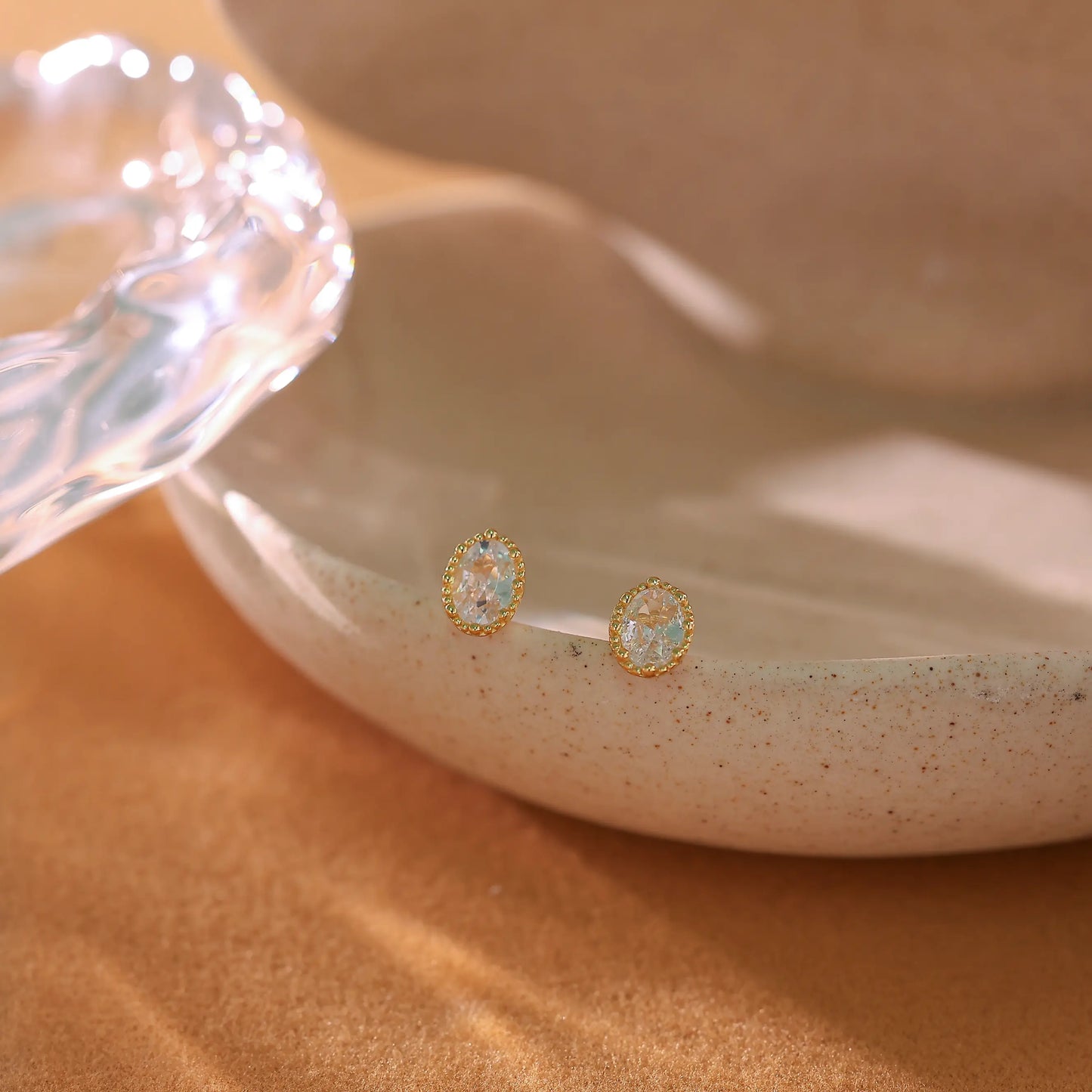 Macro shot of the oval brilliant cut diamond simulant in a 4-prong setting.