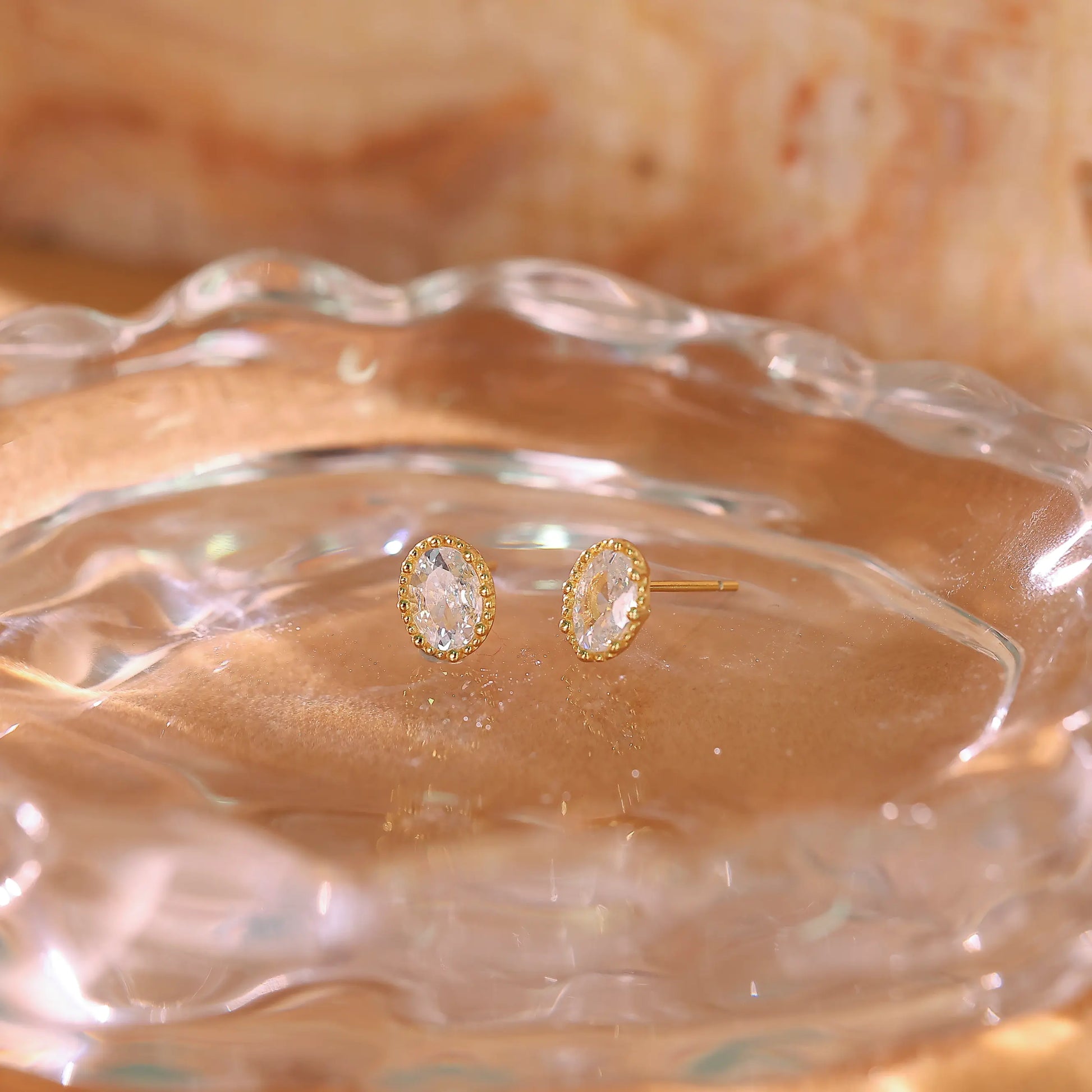Oval diamond studs displayed on a white background to show shape and clarity.