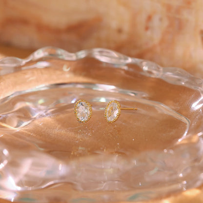 Oval diamond studs displayed on a white background to show shape and clarity.