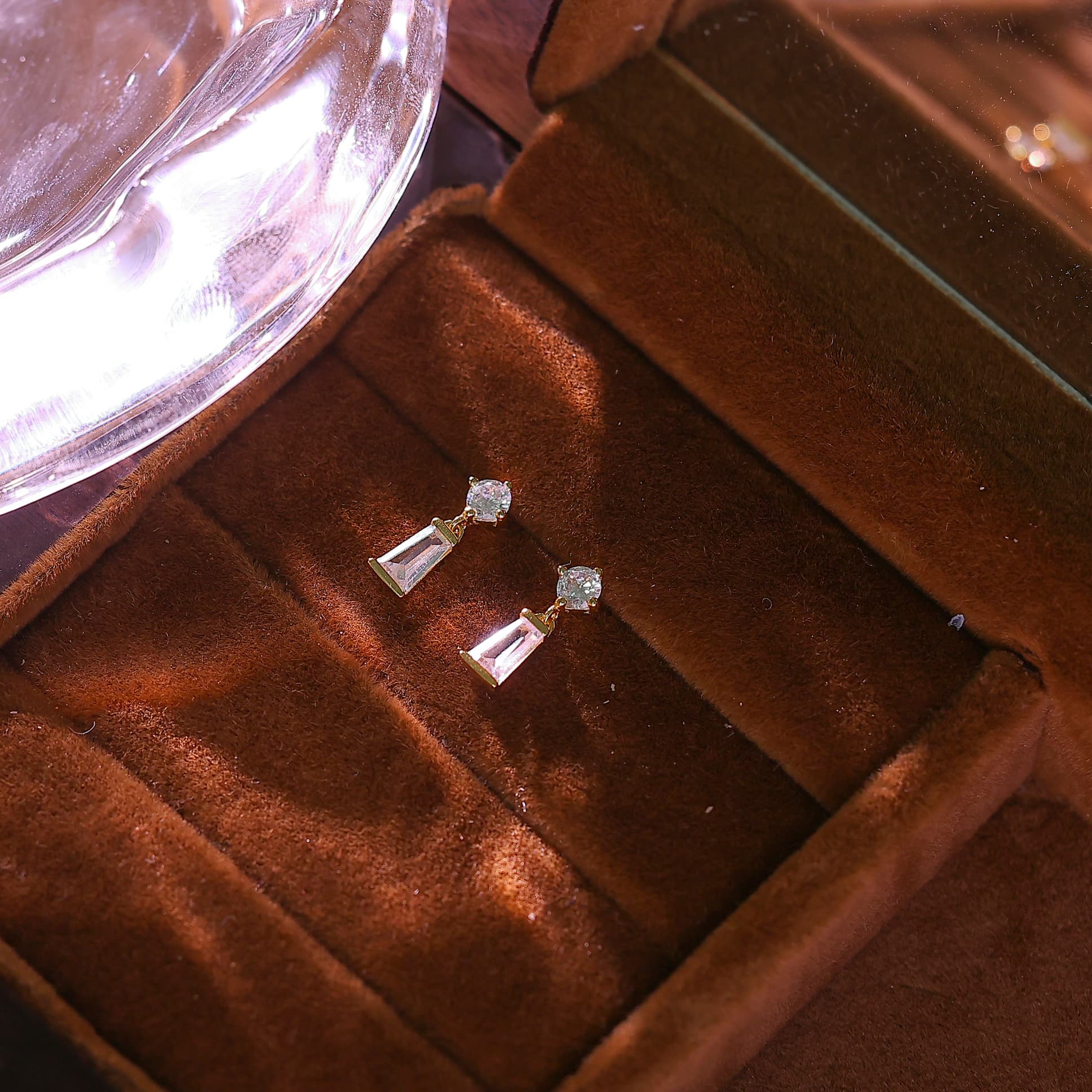 Macro shot of the rectangular baguette cut cubic zirconia hanging from a round crystal stud.