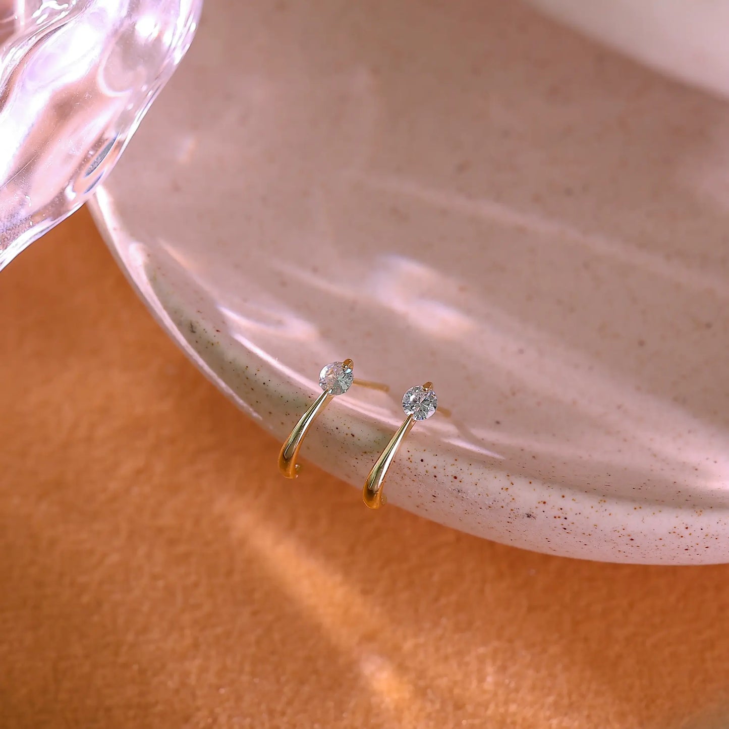 14K gold plated sterling silver open hoop earrings with clear crystals.