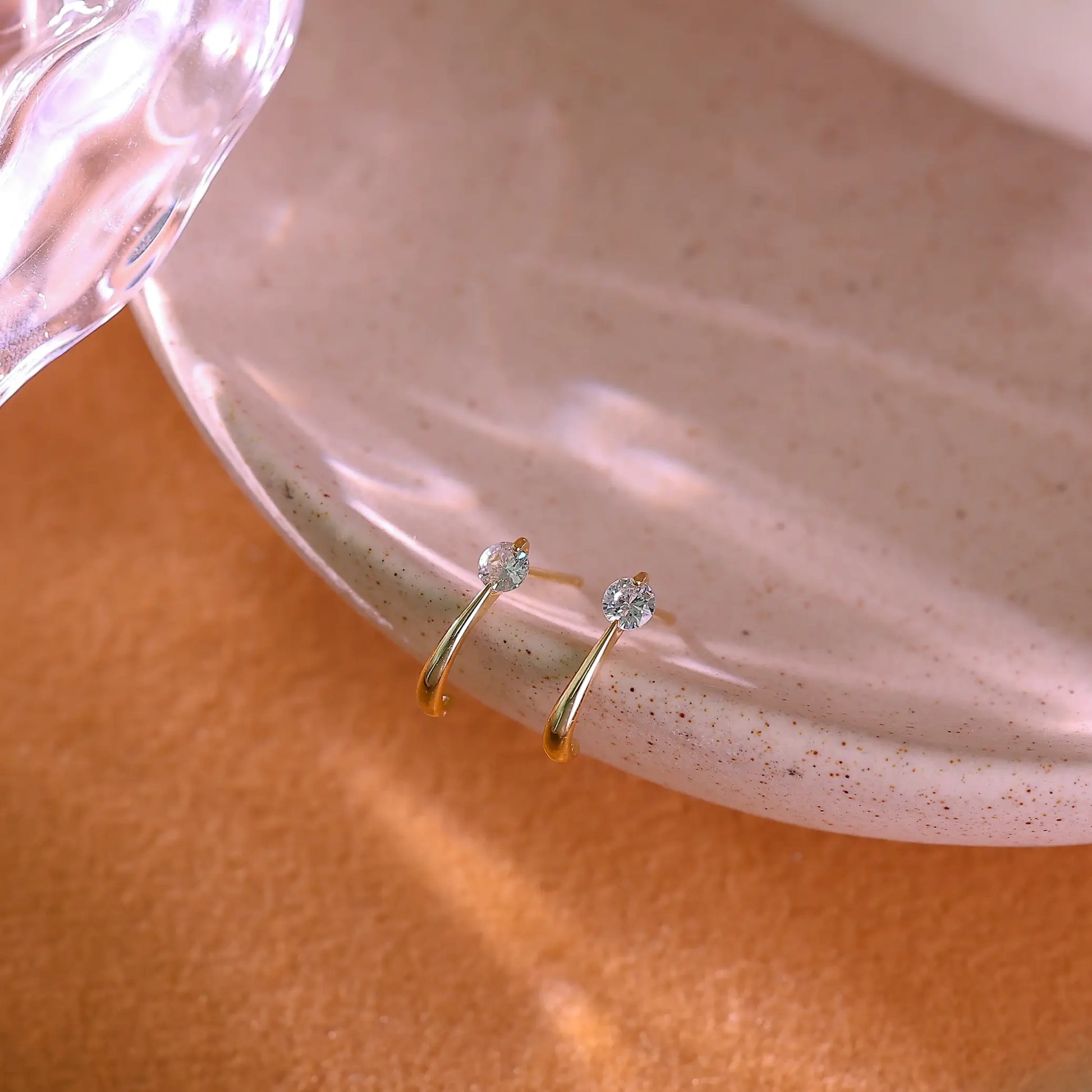 14K gold plated sterling silver open hoop earrings with clear crystals.