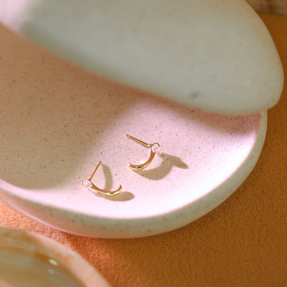 Small 925 sterling silver huggie earrings with stud post and butterfly back.