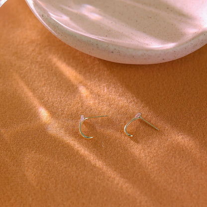 Macro shot of the tiny cubic zirconia stones set along the curve of the hoop.